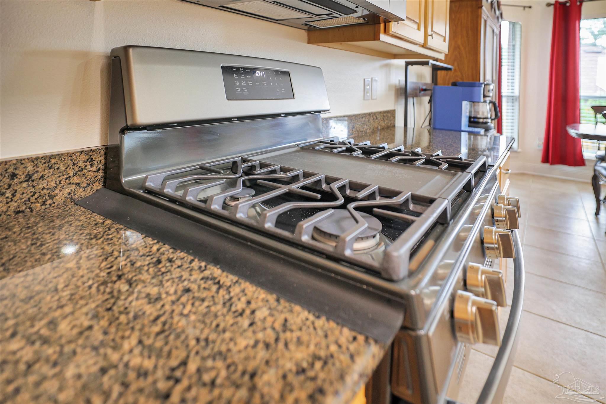 2822 Frederick Street Cantonment, FL 32533 - Photo 10 of 42 a stove top oven sitting inside of a kitchen