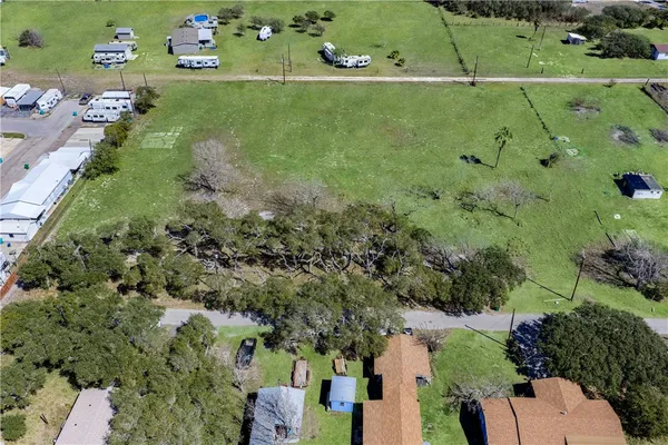 an aerial view of a houses with a yard
