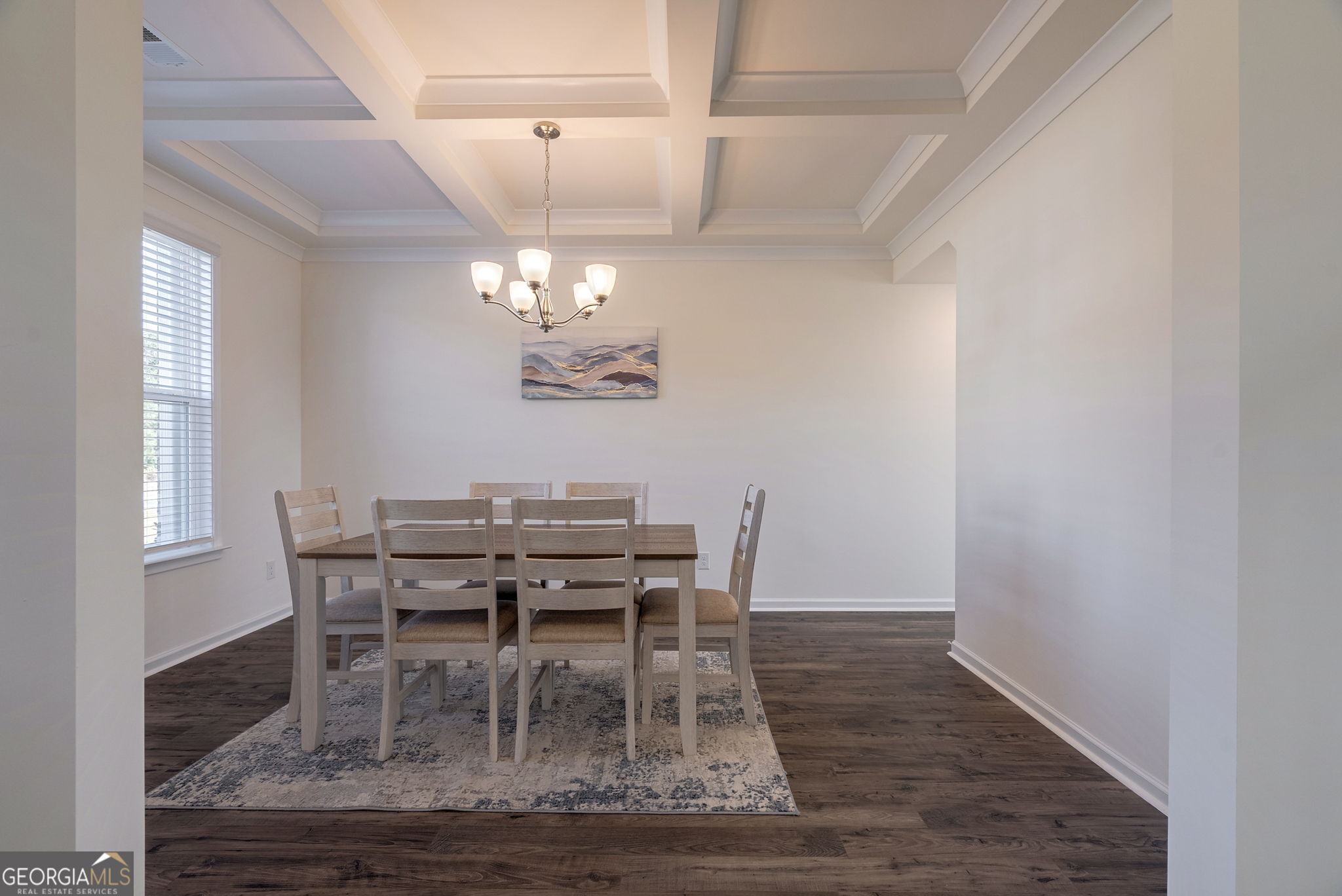1110 Brookstone Crossing Statham, GA 30666 - Photo 16 of 69 a dining room with wooden floor a chandelier a wooden table and chairs