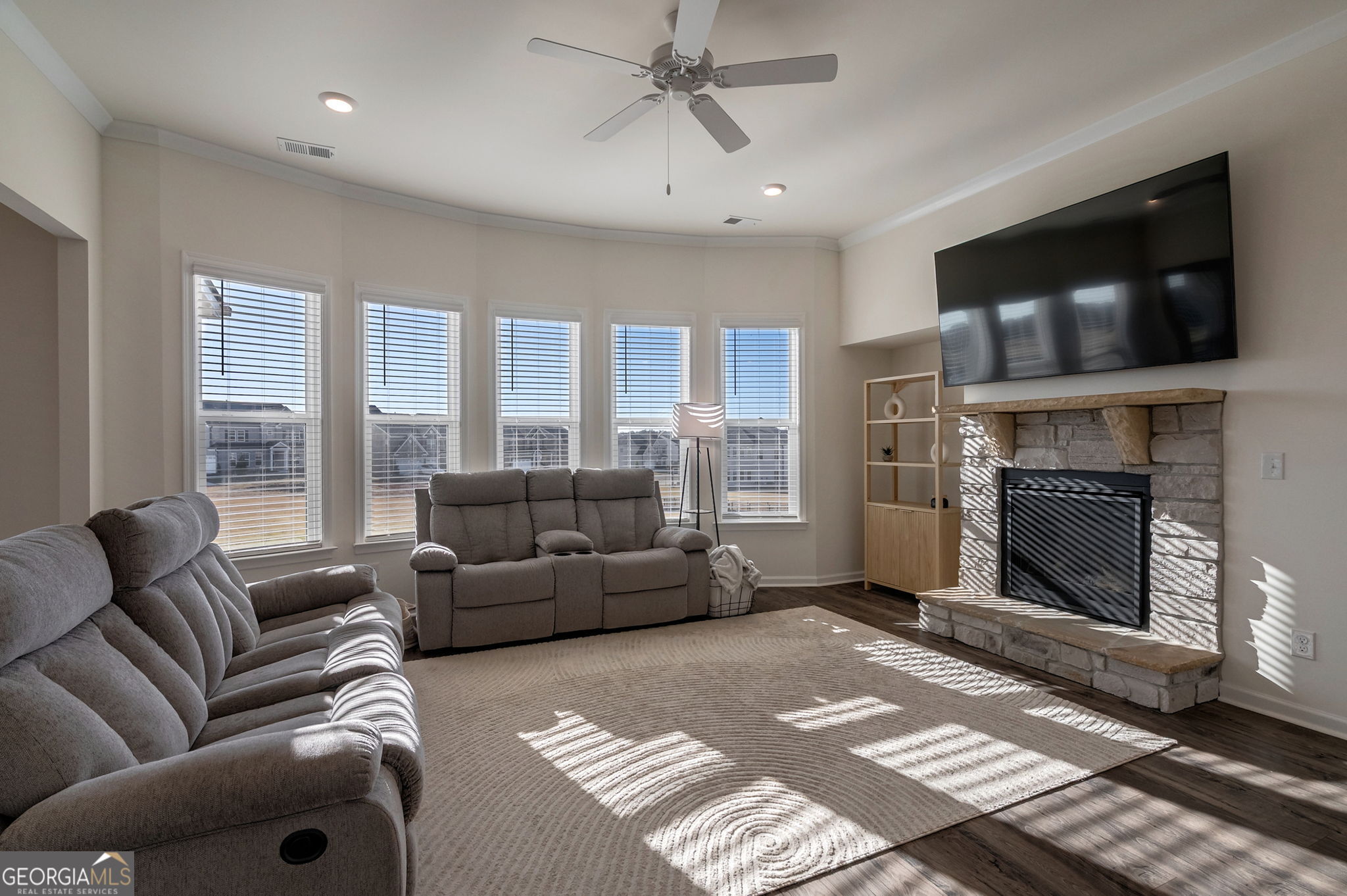 1110 Brookstone Crossing Statham, GA 30666 - Photo 21 of 69 a living room with furniture a flat screen tv and a fireplace