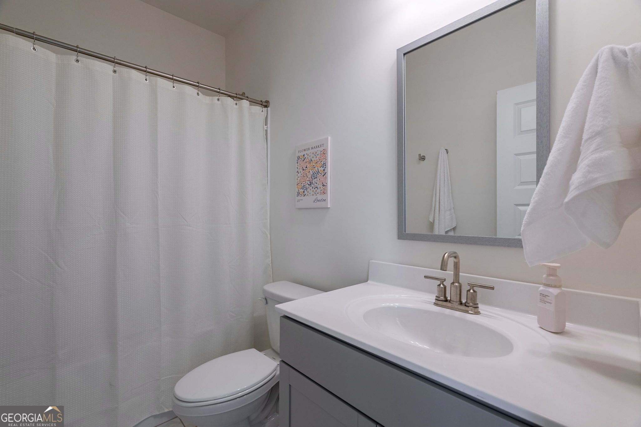 1110 Brookstone Crossing Statham, GA 30666 - Photo 29 of 69 a bathroom with a granite countertop sink toilet and a mirror