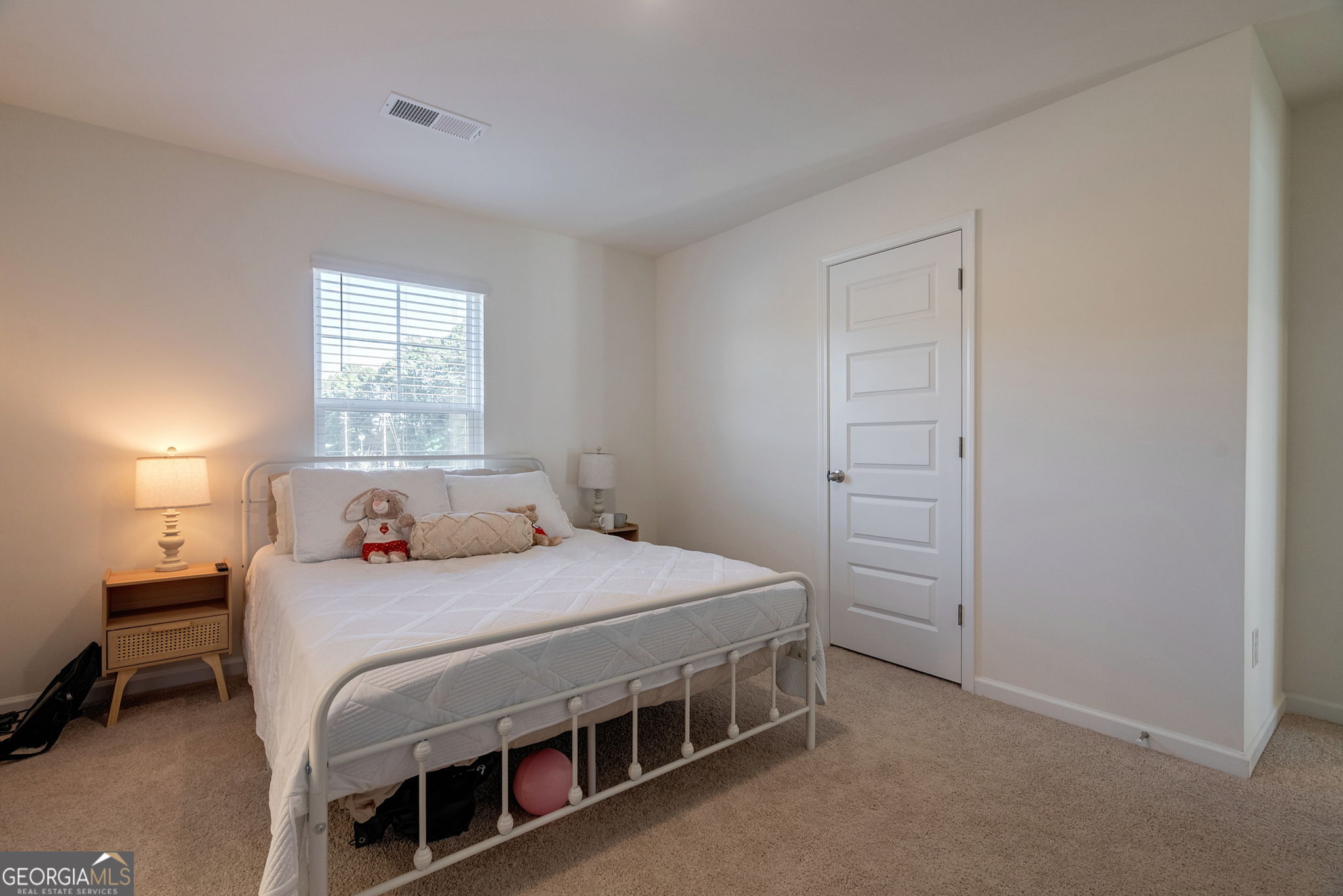 1110 Brookstone Crossing Statham, GA 30666 - Photo 48 of 69 a bedroom with a bed and a table in it