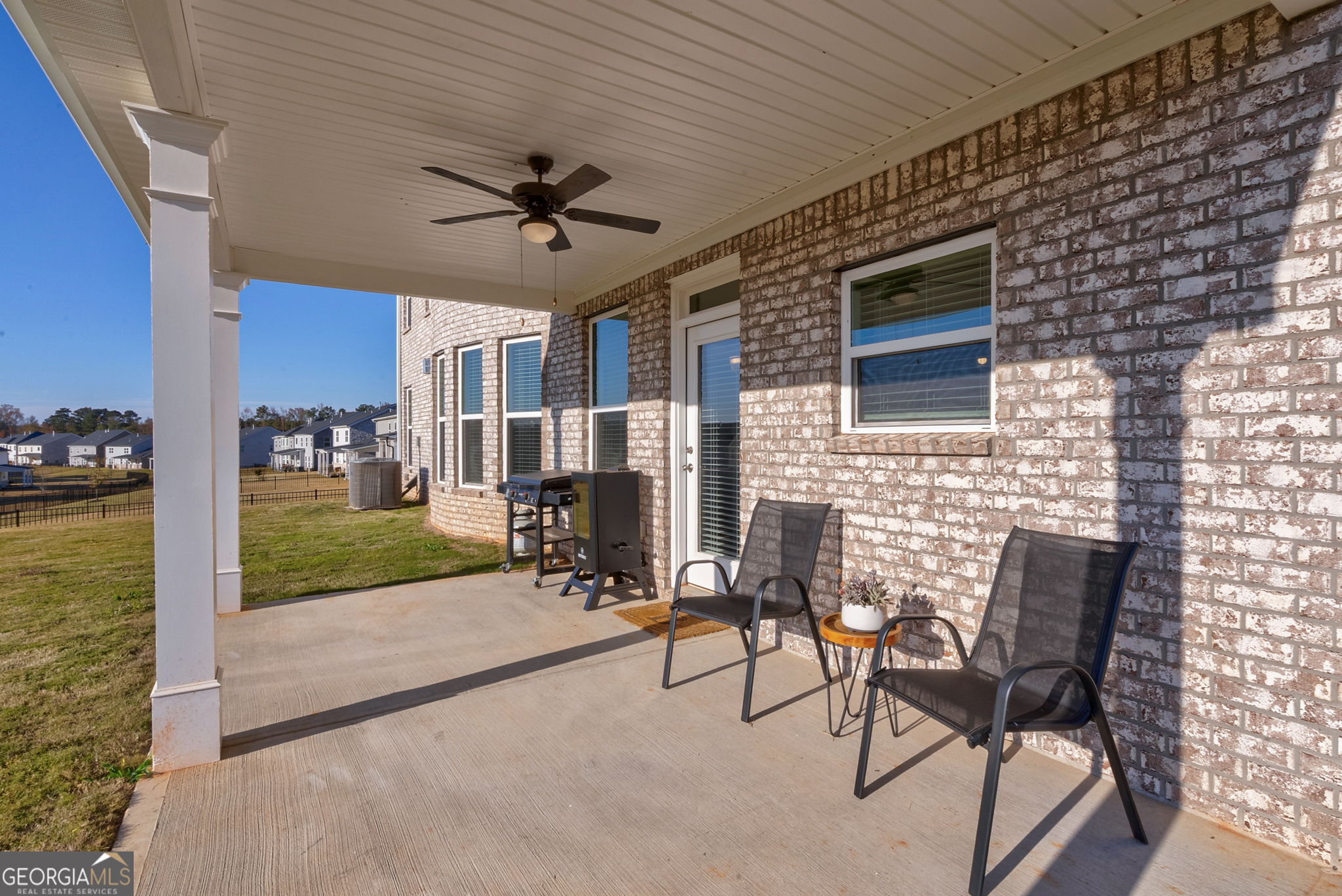 1110 Brookstone Crossing Statham, GA 30666 - Photo 58 of 69 a view of a patio with table and chairs and potted plants