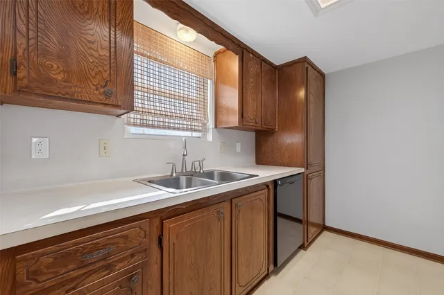 a kitchen with a sink cabinets and a window