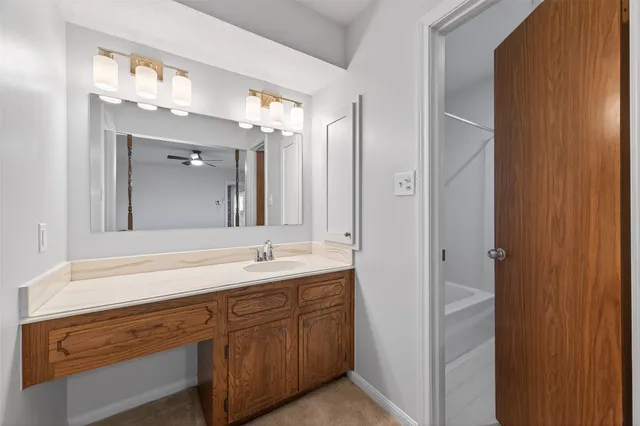a spacious bathroom with a double vanity sink and mirror
