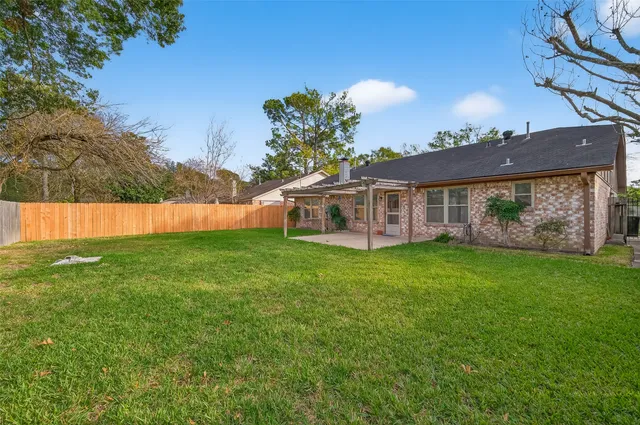 a view of a house with a backyard