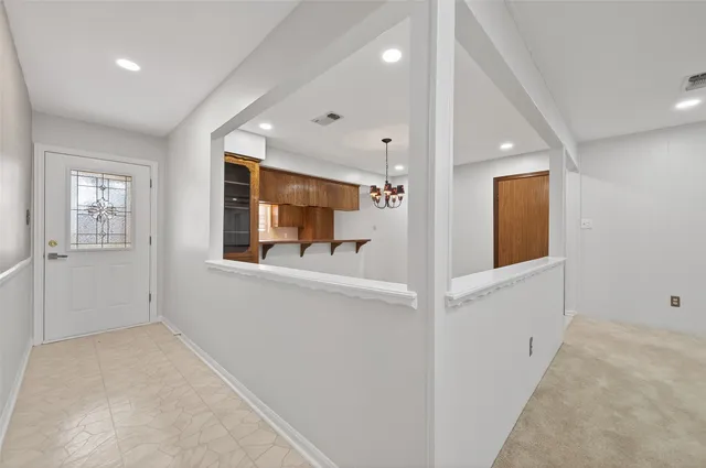 a view of hallway with chandelier