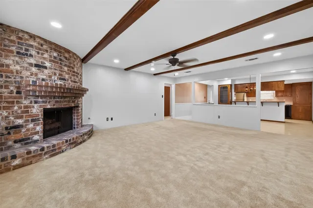 a view of an empty room with a fireplace