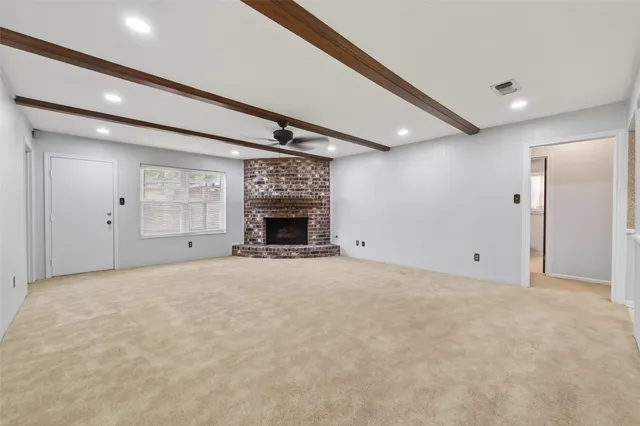 a view of empty room with a fireplace