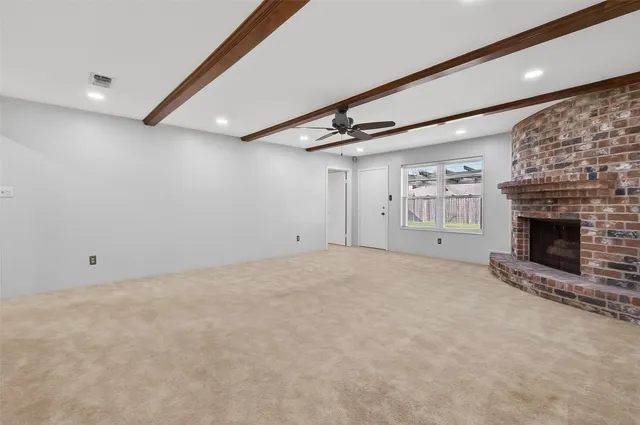 a view of an empty room with a fireplace