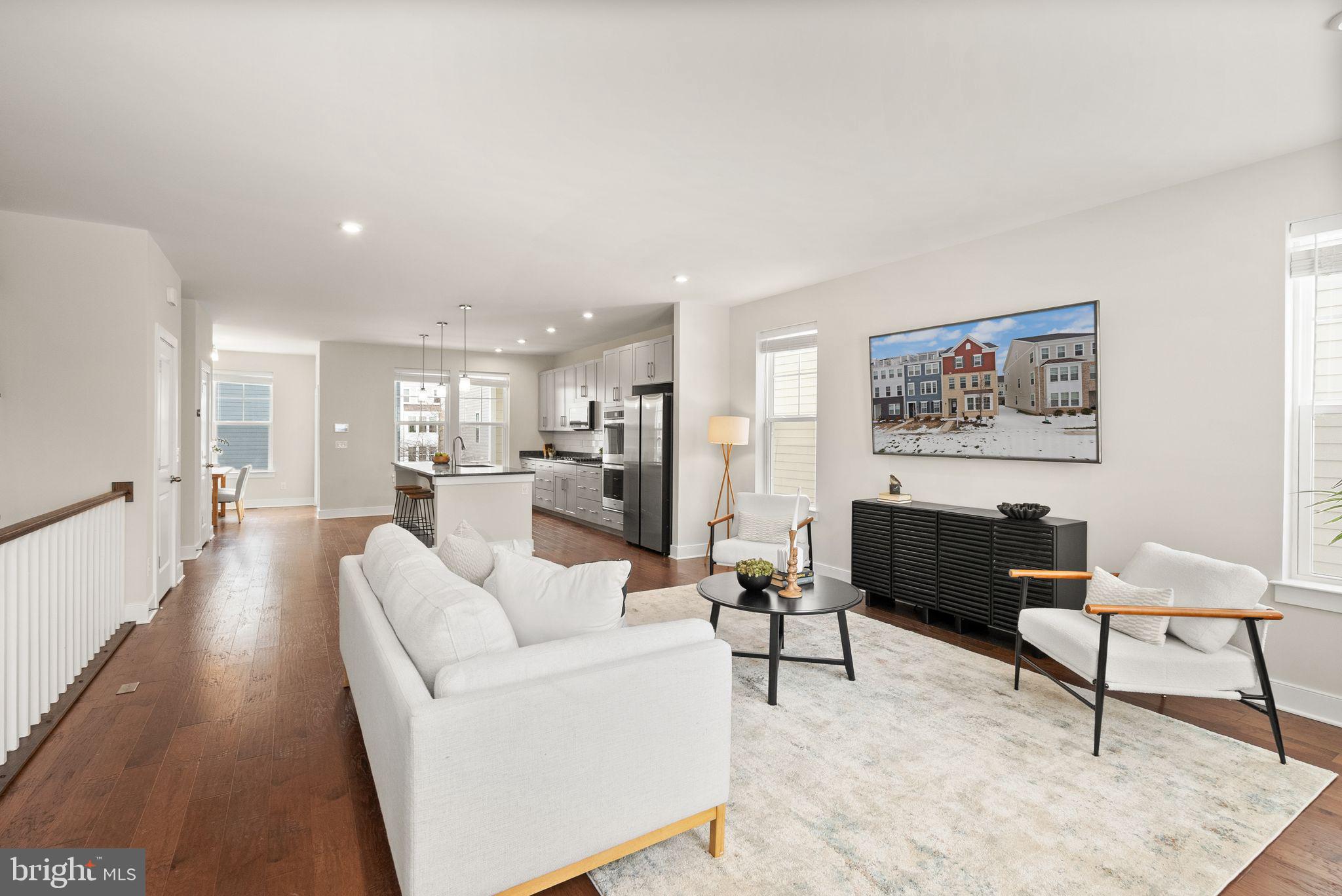 17762 Kingfisher Isle Road Dumfries, VA 22026 - Photo 20 of 62 a living room with furniture and a dining table with kitchen view