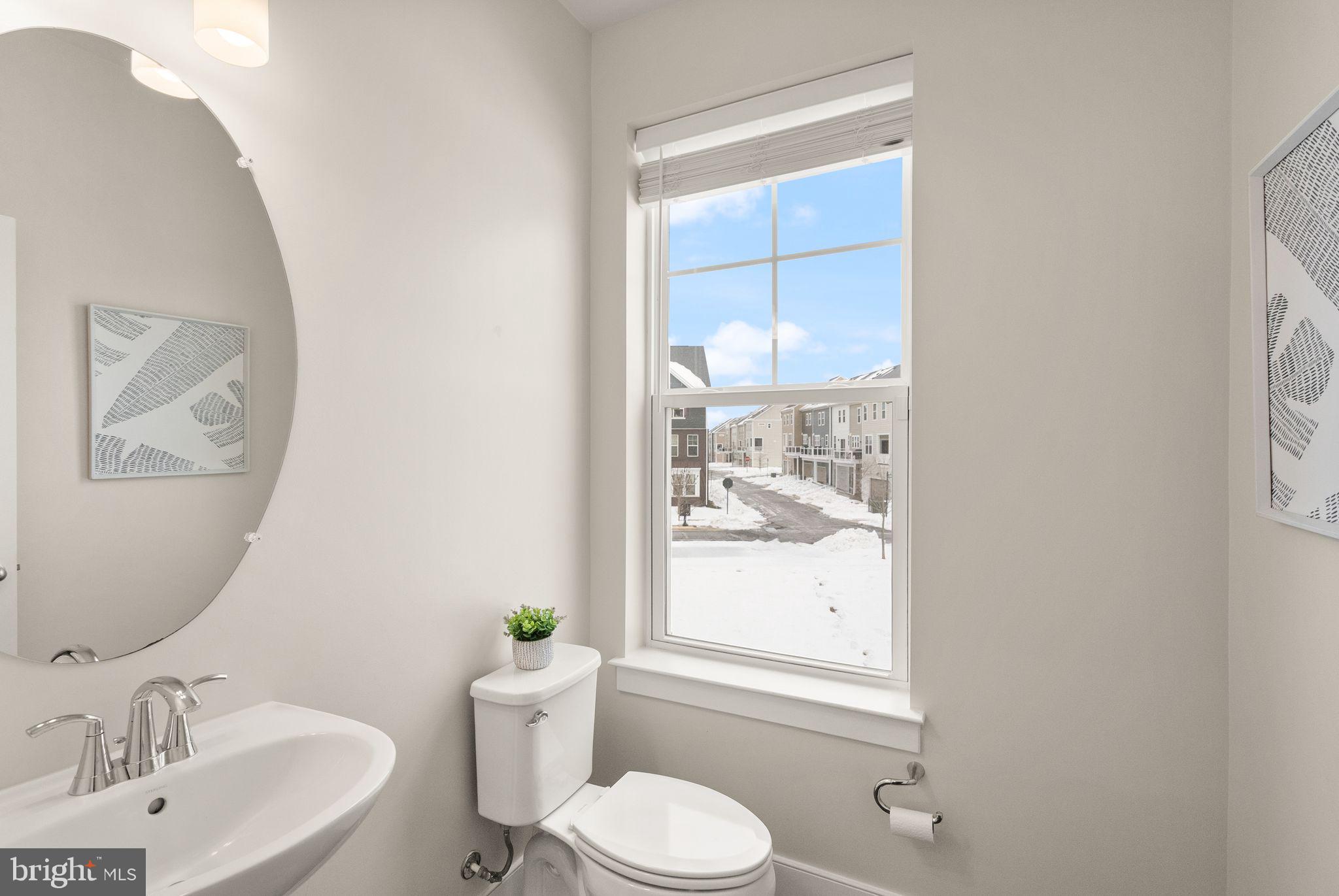17762 Kingfisher Isle Road Dumfries, VA 22026 - Photo 21 of 62 a bathroom with a sink vanity mirror and toilet
