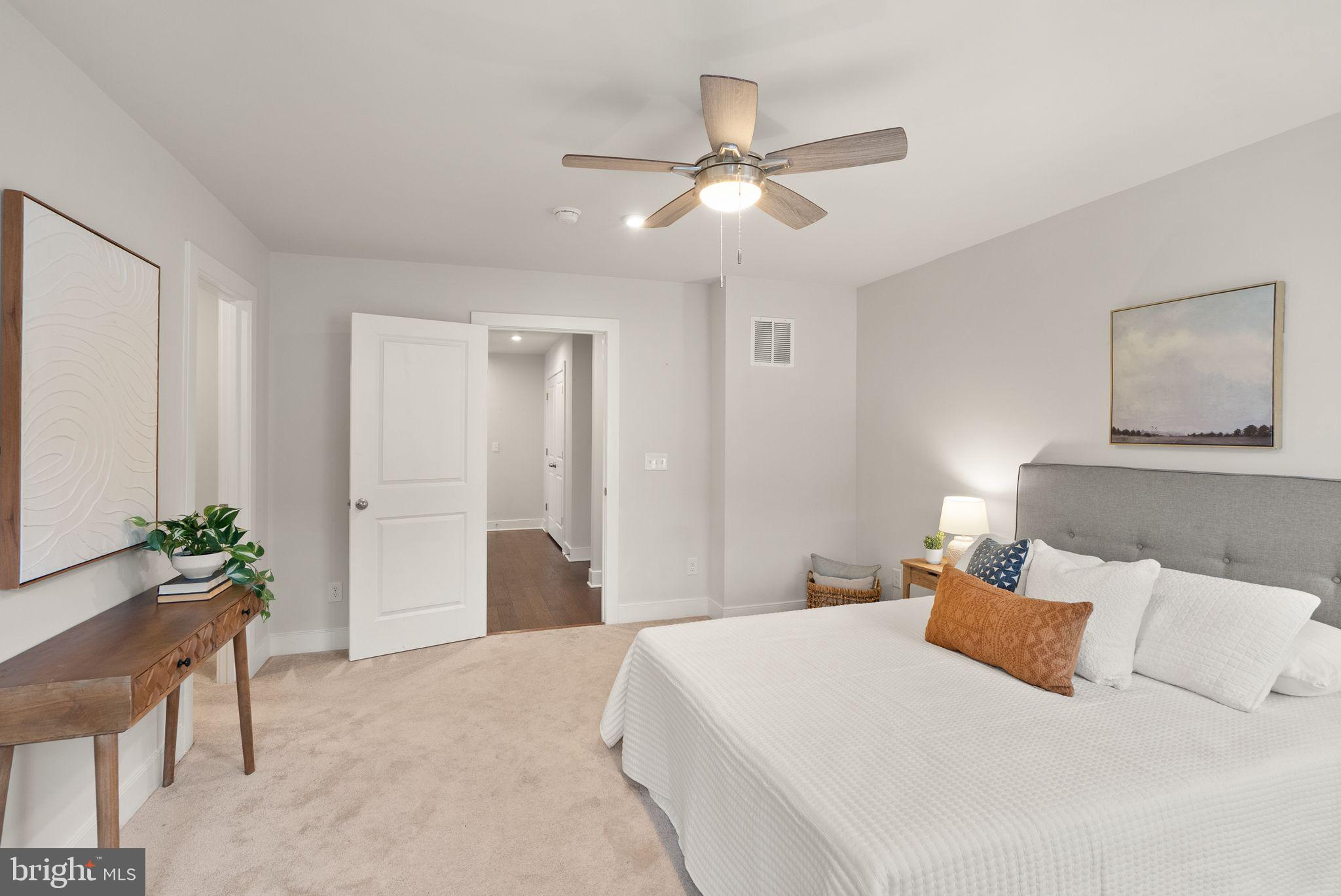 17762 Kingfisher Isle Road Dumfries, VA 22026 - Photo 26 of 62 a bedroom with a large bed and a chandelier