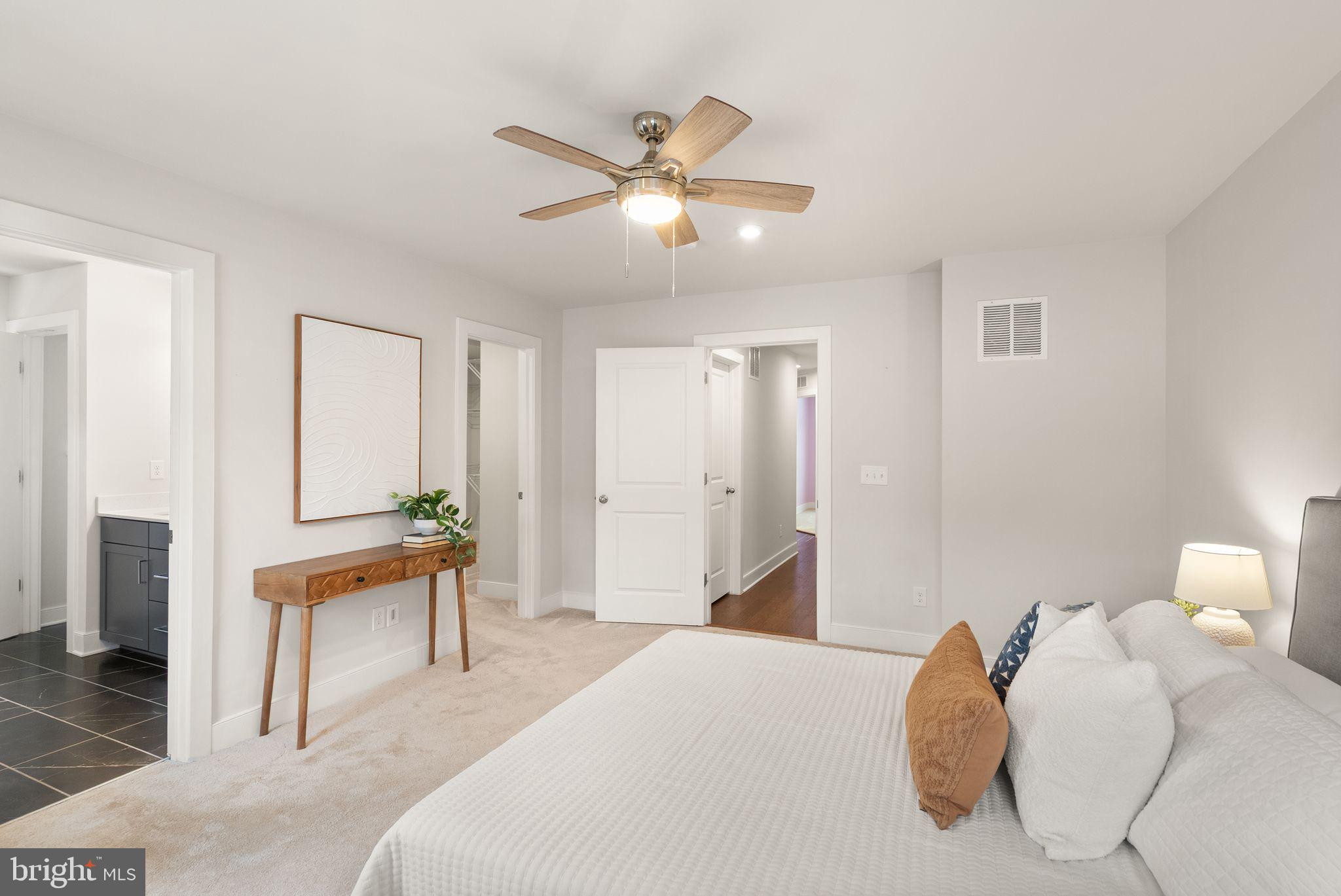 17762 Kingfisher Isle Road Dumfries, VA 22026 - Photo 27 of 62 a bedroom with a bed and a chandelier