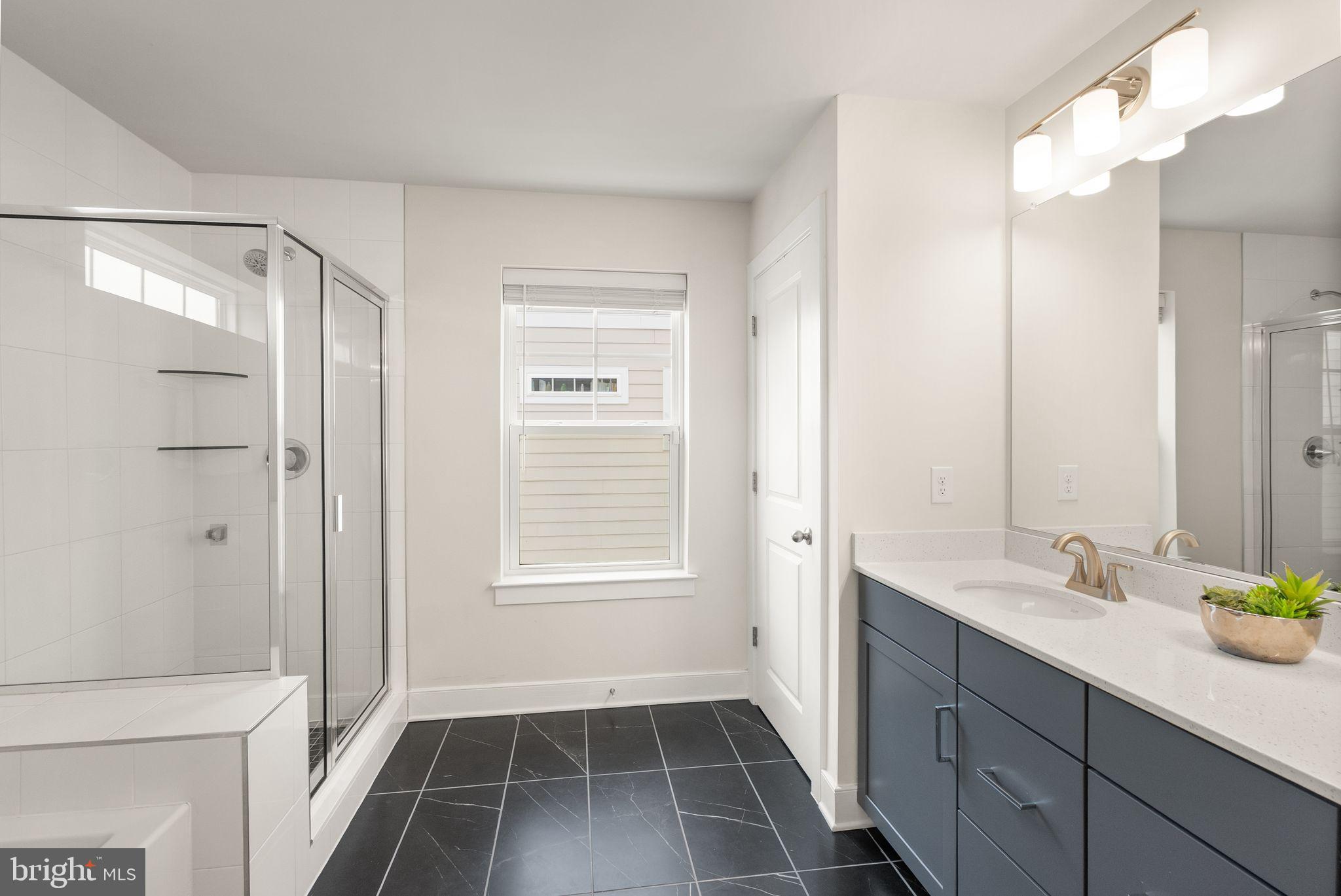 17762 Kingfisher Isle Road Dumfries, VA 22026 - Photo 28 of 62 a bathroom with a tub sink and mirror