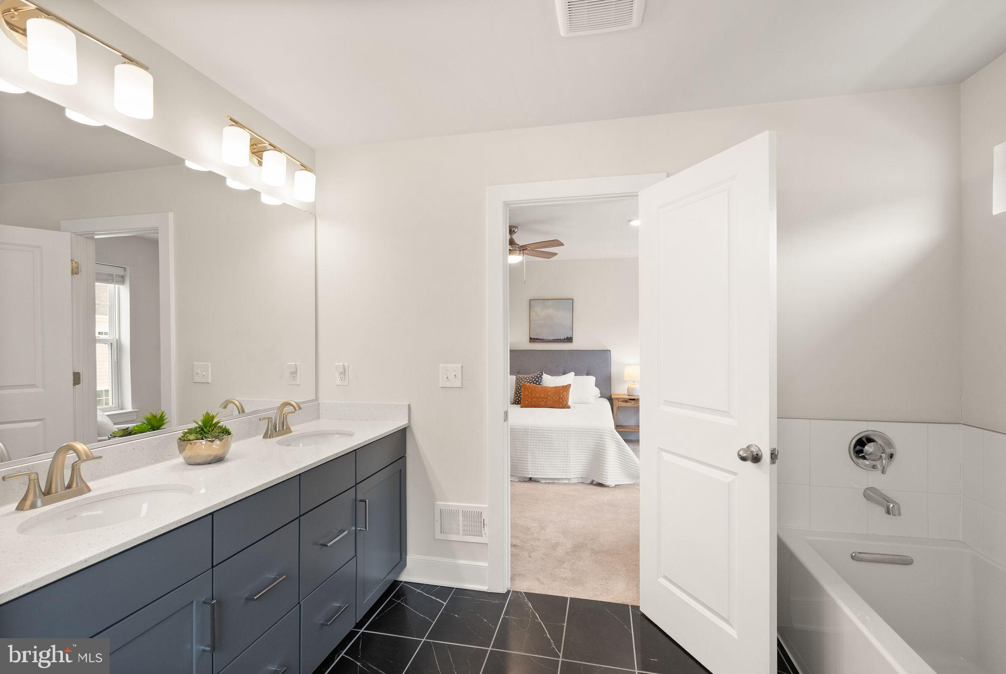 17762 Kingfisher Isle Road Dumfries, VA 22026 - Photo 30 of 62 a bathroom with a tub sink and mirror