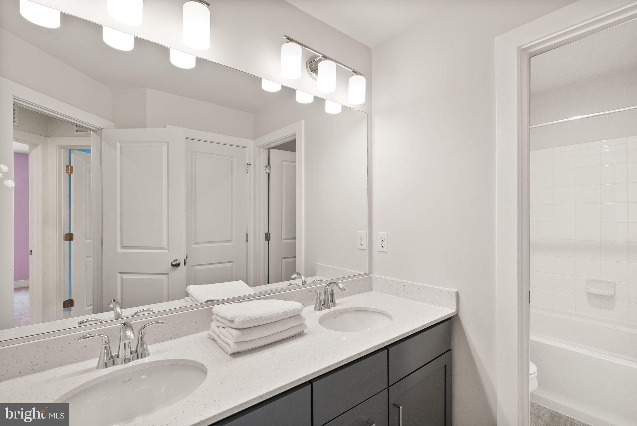 17762 Kingfisher Isle Road Dumfries, VA 22026 - Photo 38 of 62 a bathroom with double vanity sinks and a mirror