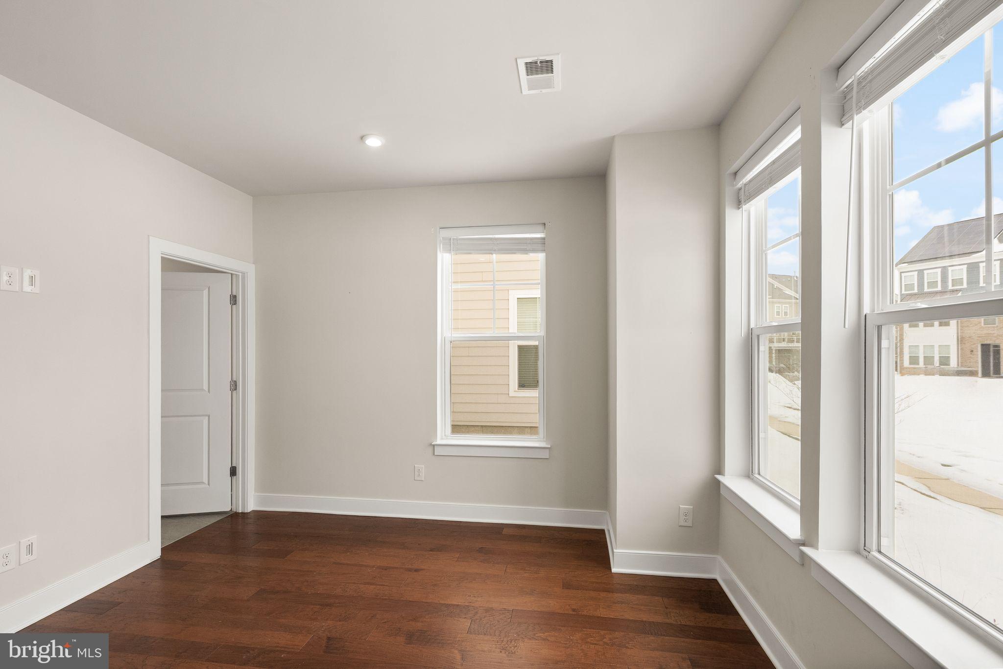 17762 Kingfisher Isle Road Dumfries, VA 22026 - Photo 41 of 62 a view of an empty room with wooden floor and a window