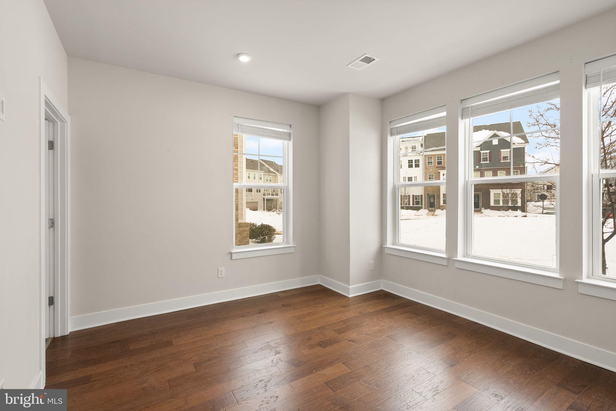 17762 Kingfisher Isle Road Dumfries, VA 22026 - Photo 44 of 62 an empty room with wooden floor and windows