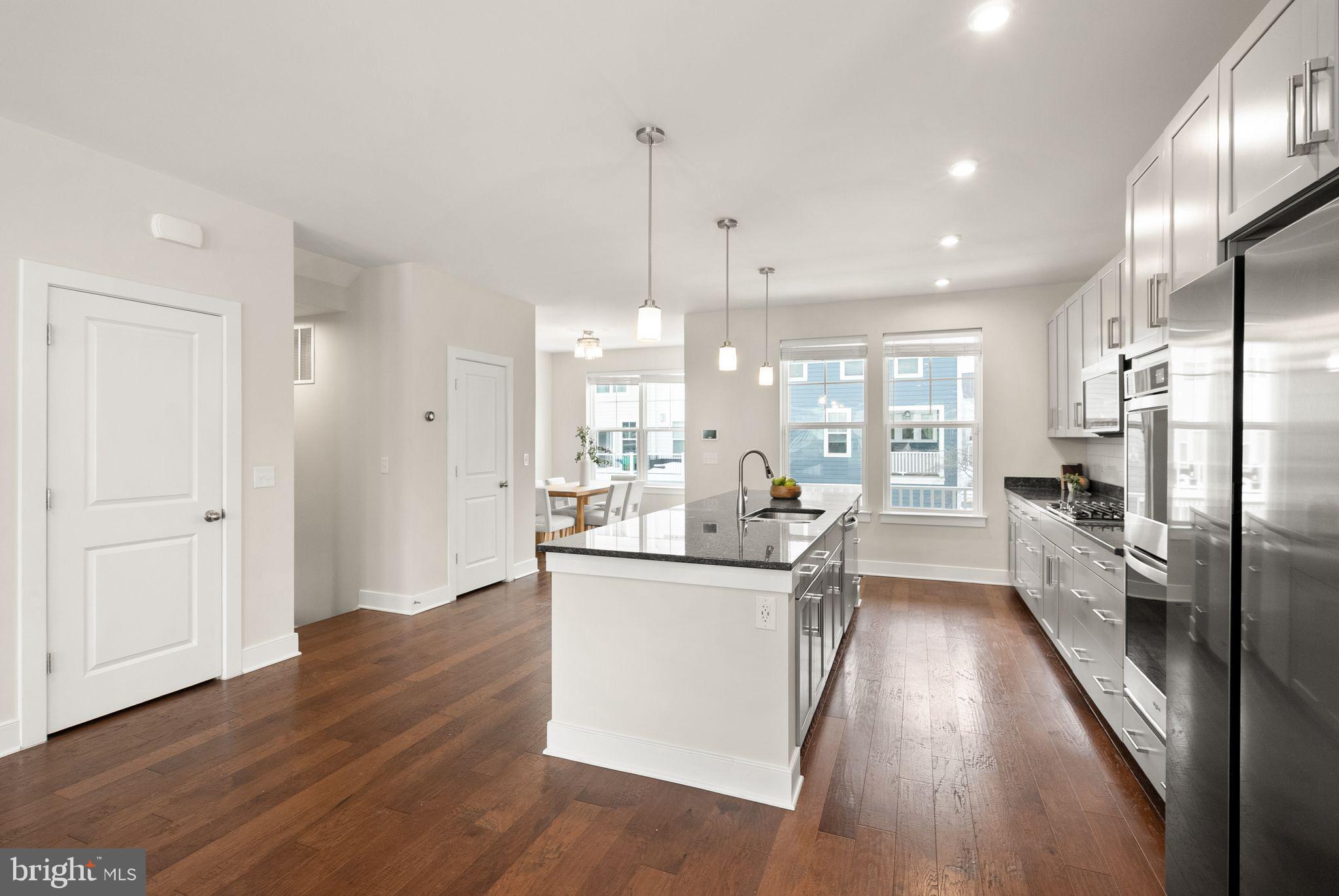 17762 Kingfisher Isle Road Dumfries, VA 22026 - Photo 10 of 62 a kitchen with stainless steel appliances a refrigerator a sink dishwasher a stove and white cabinets with wooden floor