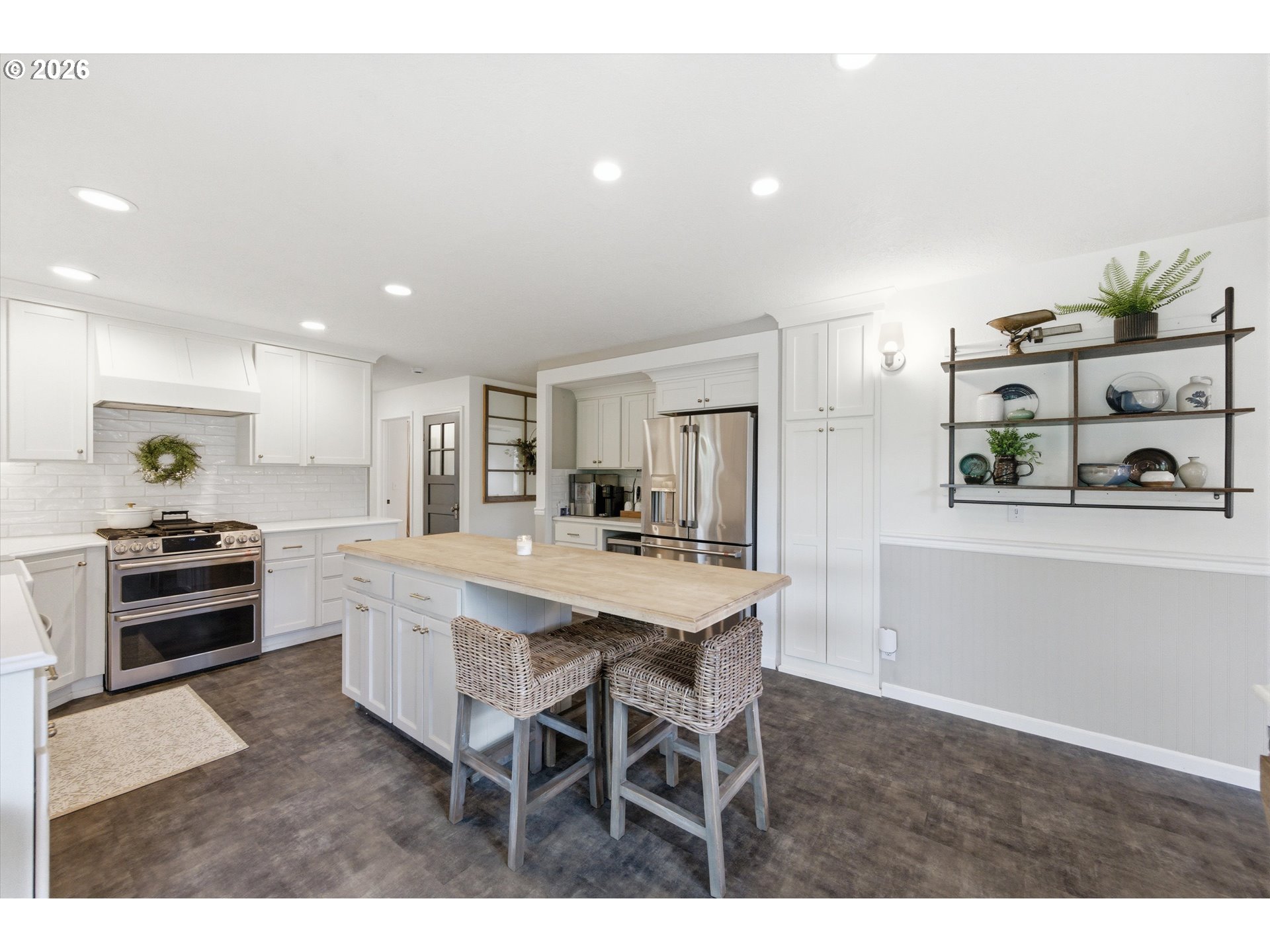 13880 McCaleb Road Monmouth, OR 97361 - Photo 15 of 44 a kitchen with stainless steel appliances kitchen island granite countertop a table and chairs in it