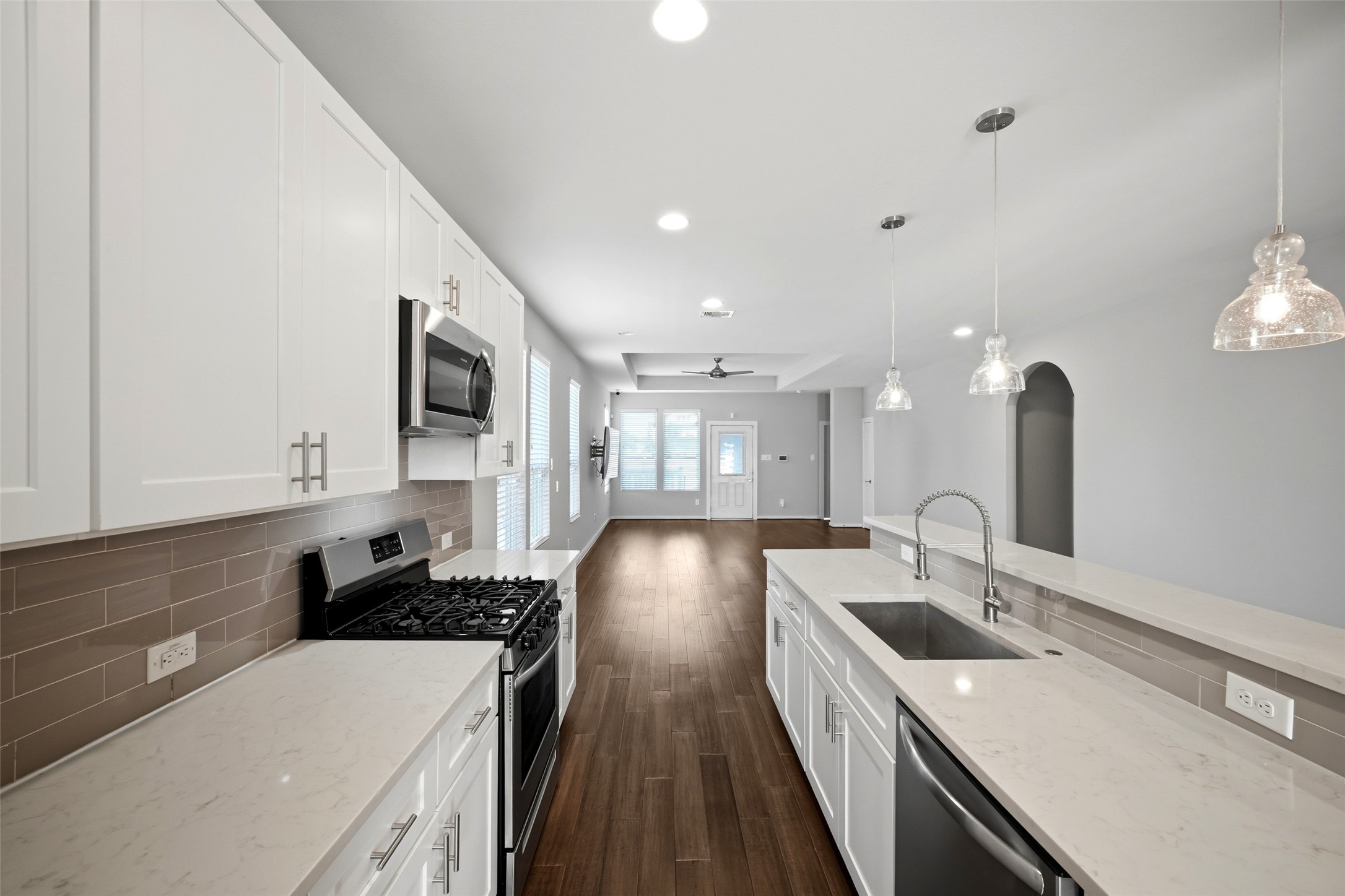 605 Dumble Street Houston, TX 77023 - Photo 20 of 44 a kitchen with sink a stove and cabinets