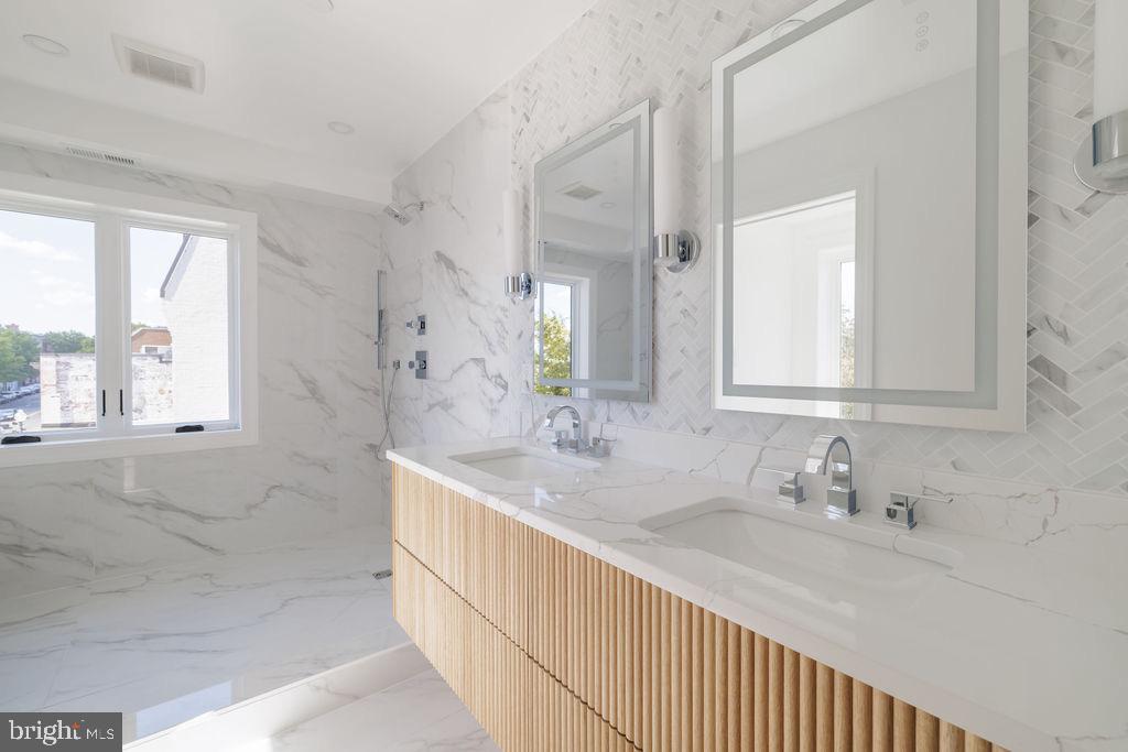 1202 Potomac Street Northwest Washington, DC 20007 - Photo 19 of 37 a bathroom with double vanity sinks and a large mirror