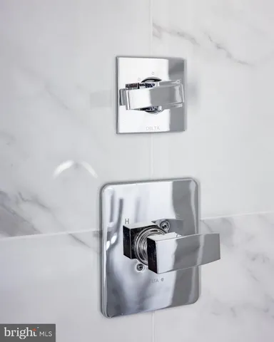 a white bath tub sitting in a bathroom next to a window