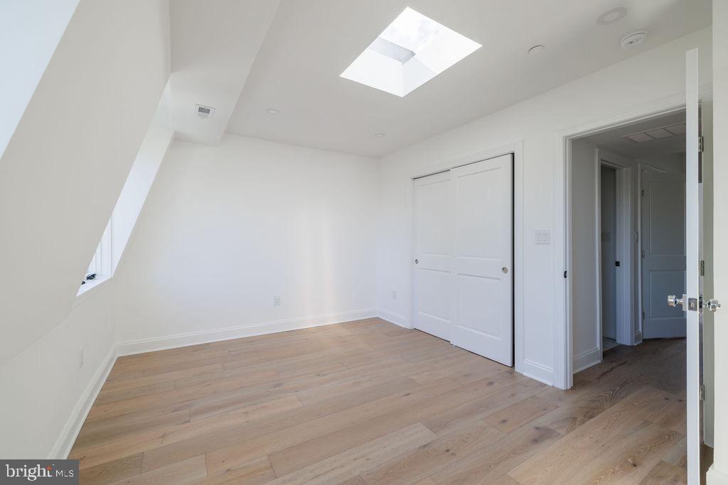 1202 Potomac Street Northwest Washington, DC 20007 - Photo 26 of 37 an empty room with wooden floor and windows