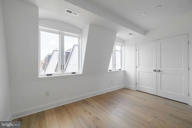 a view of a room with wooden floor