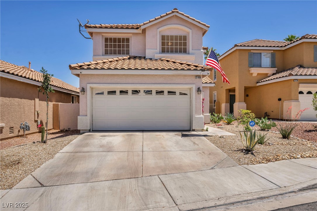 View of front of home featuring concrete driveway,