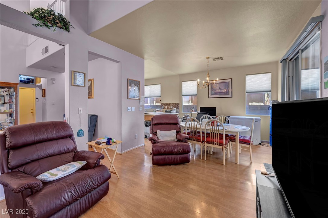 2180 Polynesia Circle Henderson, NV 89074 - Photo 13 of 53 Living area featuring a chandelier, light wood-sty