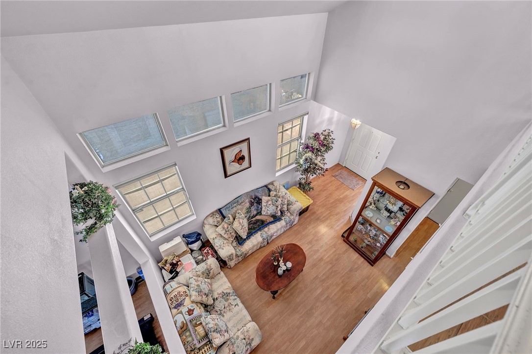 2180 Polynesia Circle Henderson, NV 89074 - Photo 21 of 53 Living room featuring a high ceiling and wood fini