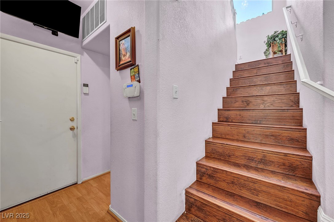 2180 Polynesia Circle Henderson, NV 89074 - Photo 22 of 53 Stairs featuring wood finished floors and a textur