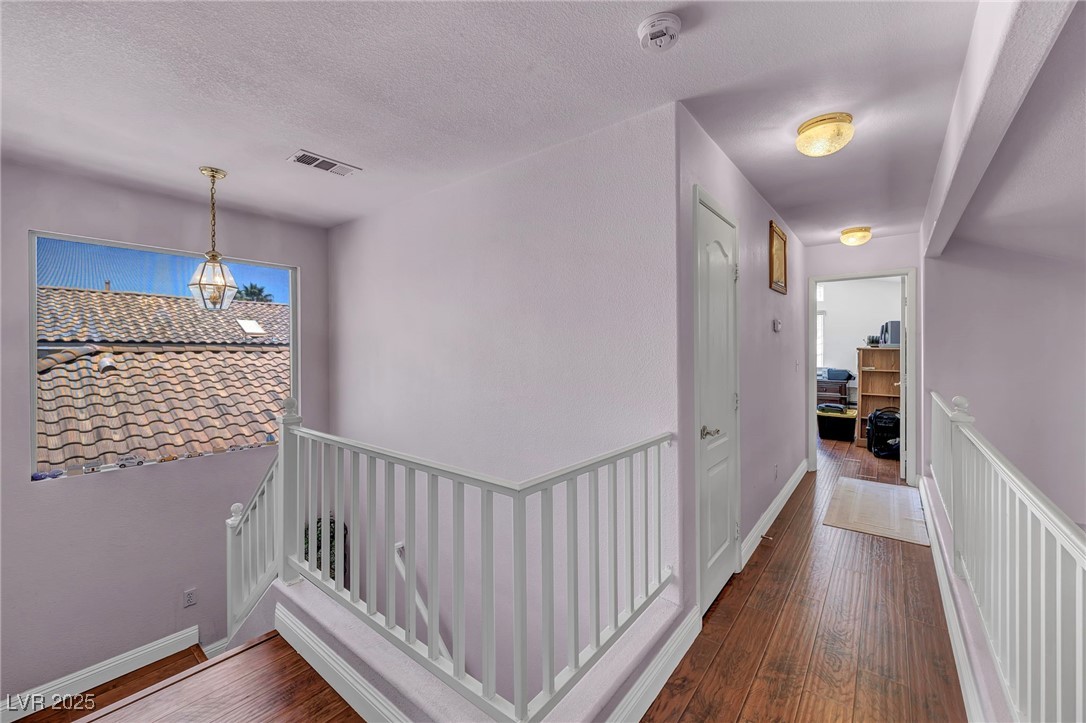 2180 Polynesia Circle Henderson, NV 89074 - Photo 23 of 53 Hall featuring hardwood / wood-style floors, an up