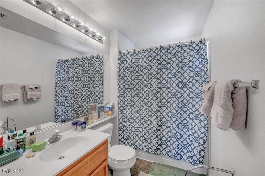 2180 Polynesia Circle Henderson, NV 89074 - Photo 24 of 53 Bathroom with toilet, curtained shower, and vanity
