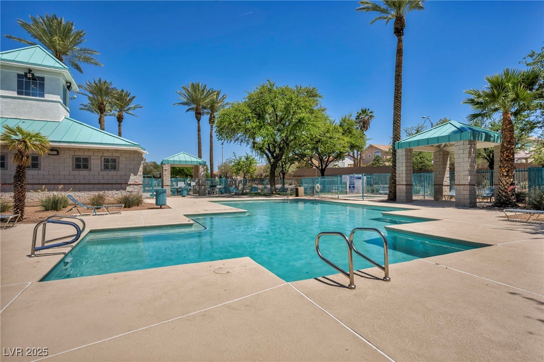 2180 Polynesia Circle Henderson, NV 89074 - Photo 39 of 53 Community pool with fence and a patio
