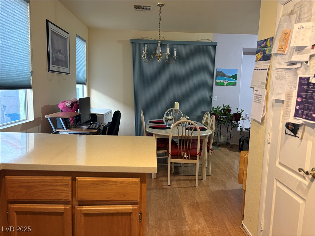 2180 Polynesia Circle Henderson, NV 89074 - Photo 46 of 53 Dining space featuring a chandelier and light wood