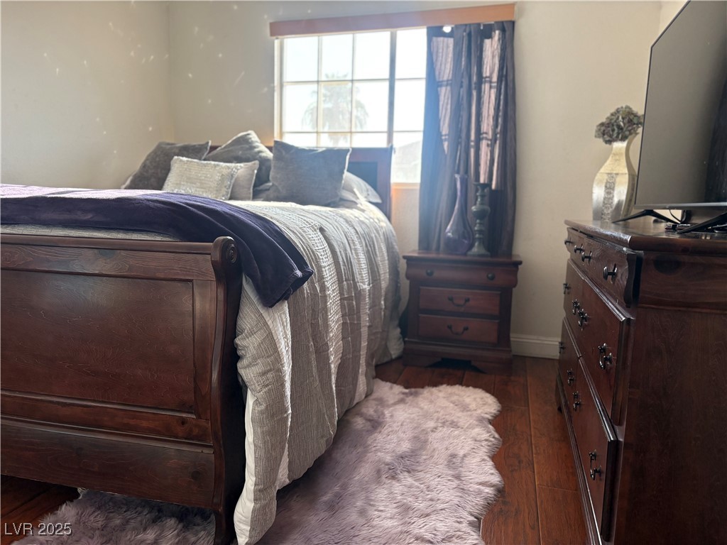 2180 Polynesia Circle Henderson, NV 89074 - Photo 49 of 53 Bedroom with dark wood finished floors and baseboa