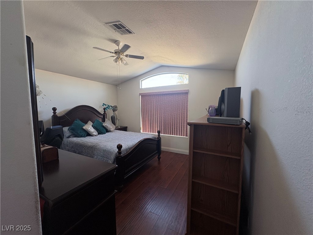 2180 Polynesia Circle Henderson, NV 89074 - Photo 52 of 53 Master Bedroom with lofted ceiling, dark wood-styl