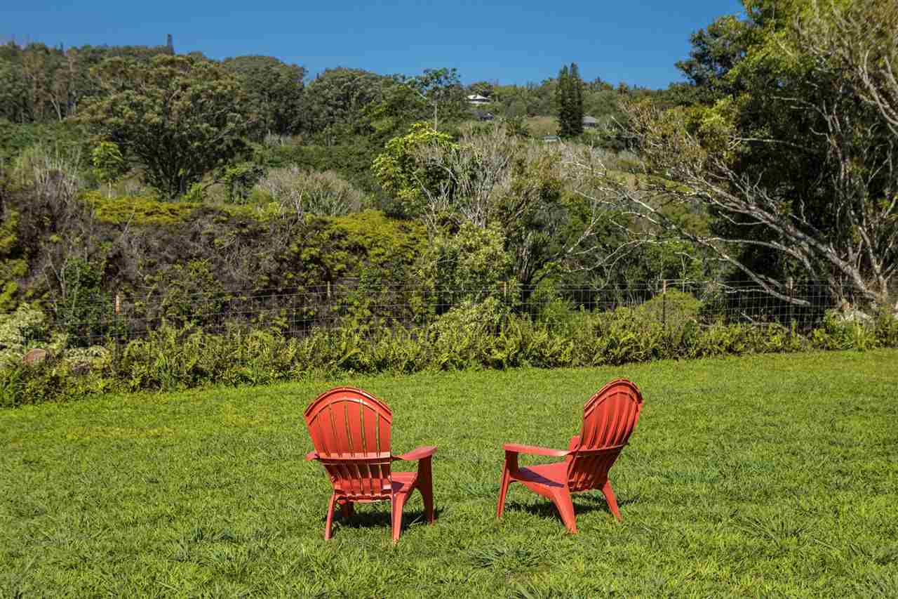 1351 Hookili Road, Unit A Haiku, HI 96708 - Photo 24 of 29 a view of a backyard with table and chairs and a barbeque