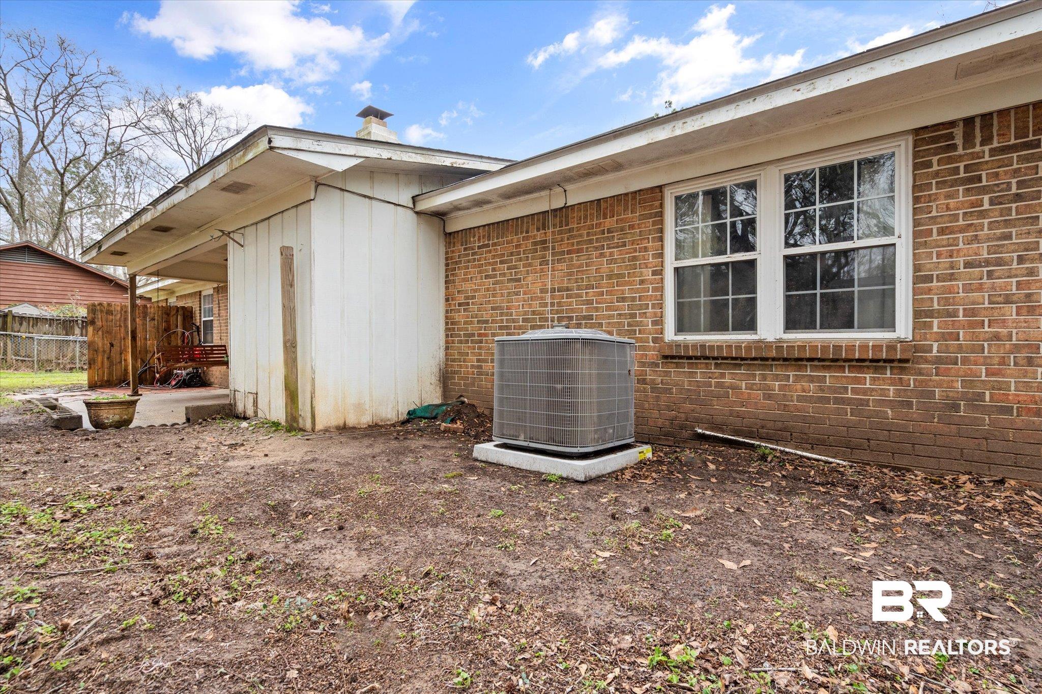 3541 Winston Drive Semmes, AL 36575 - Photo 16 of 20 View of property exterior with fence, cooling unit, and brick siding