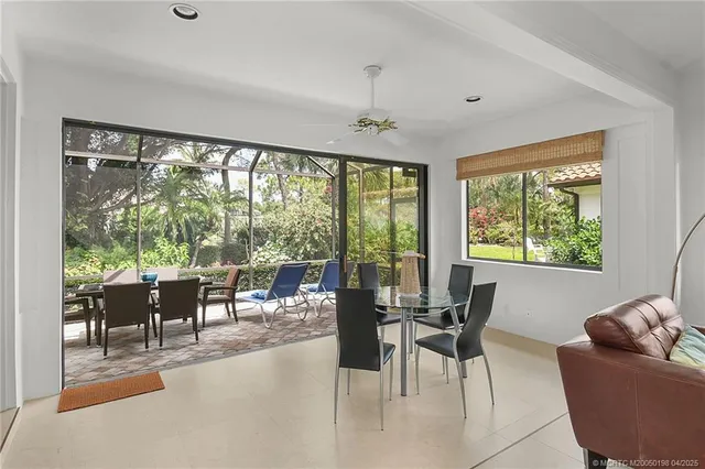 a kitchen with stainless steel appliances granite countertop a refrigerator a sink dishwasher a stove and white cabinets with wooden floor