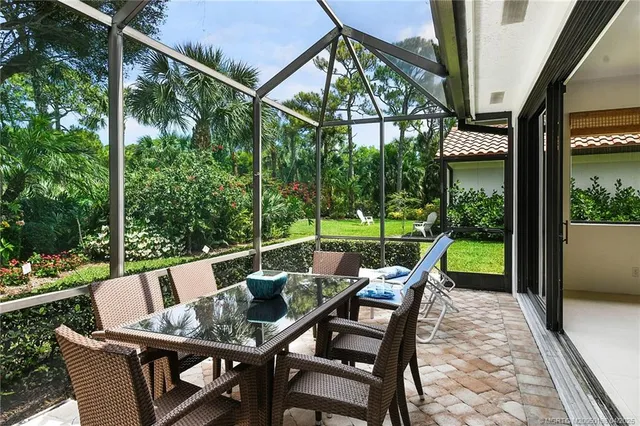 a front view of a house with a yard and shrubs