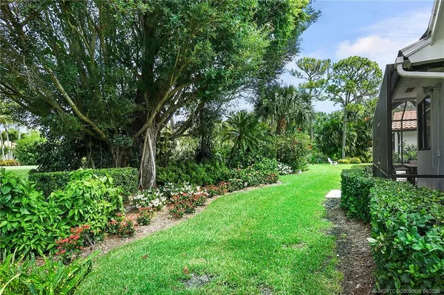 an aerial view of a house with garden space and sitting area