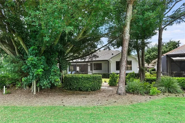 an aerial view of a house with a garden and trees