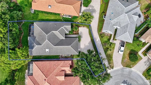 an aerial view of a house with a swimming pool yard and outdoor seating