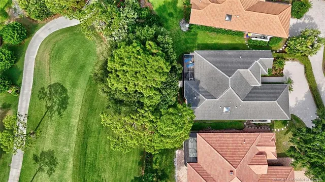 a room with lots of tables a large window and chairs