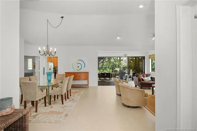 a view of a dining room with furniture and a chandelier