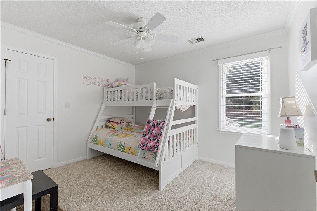 114 Halifax Road Easley, SC 29642 - Photo 21 of 32 This spacious bedroom offers ample natural light and a comfortable ambiance perfect for rest.